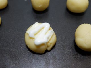 咸香芝士曲奇饼干,蛋黄酱装入裱花袋，或者用挤酱瓶，挤在芝士片上方即可。