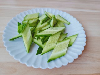 黄瓜木耳炒鸡蛋,黄瓜削皮斜着切成小段，再切成菱形状。